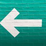 selective focus photography of white arrow signage